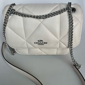 White leather puffer coach bag.